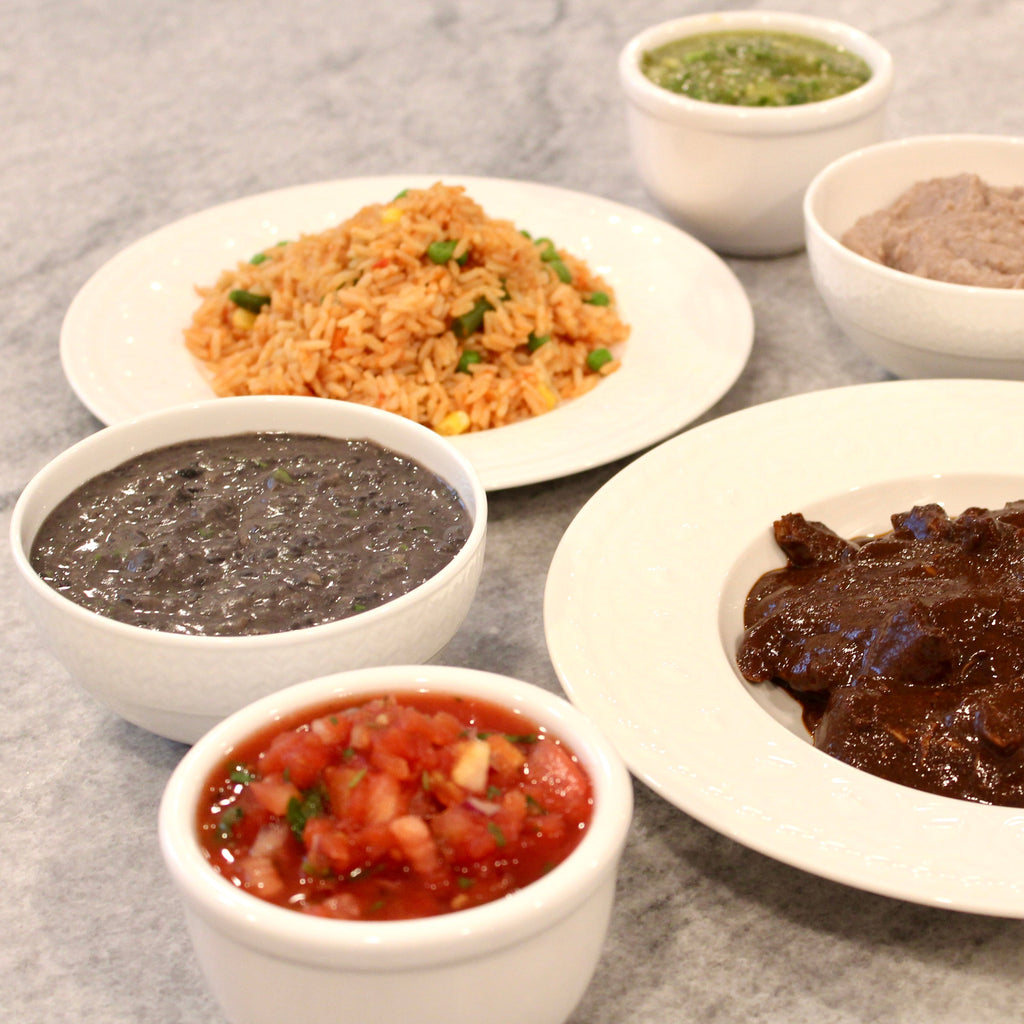 Pictured with Chicken Mole, Salsa Roja, Mexican Rice with Vegetables, Green Tomatillo Salsa & Refried Pinto Beans.