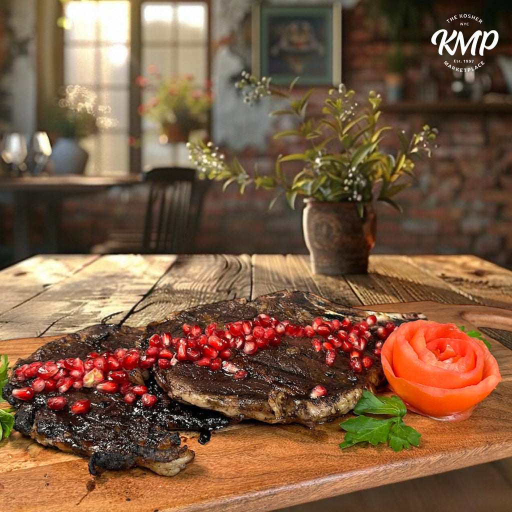 Steak with pomegranate seeds and a carrot rose on a wooden table, with 'KMP' branding.